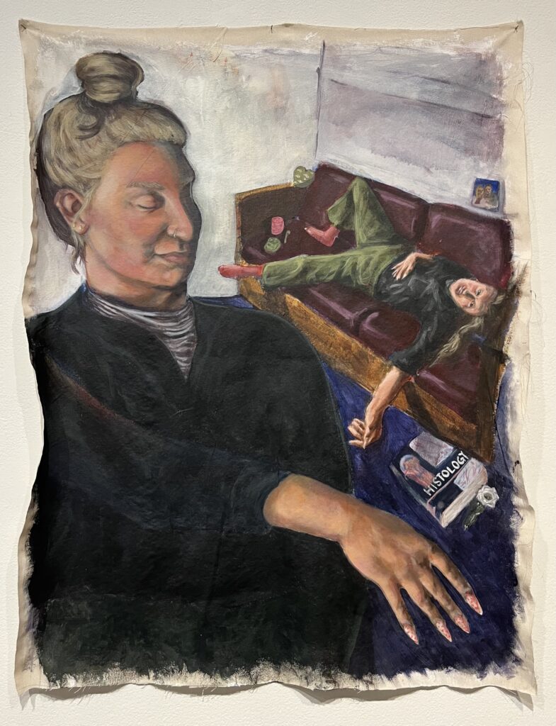 Two of the same person is in this painting. They are white and wearing a black shirt with green pants and red socks. The front half of their hair is dyed blond, the rest is brown. The foreground features a large scale version of them looking down to the right with their arm outstretched. The background features them laying down on a maroon couch surrounded by a crochet hook, yard, a pipe, a photo of their parents, a histology textbook, and a green wooden heart.
